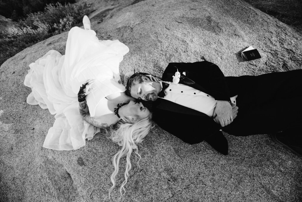 A couple laying down Glacier Point Elopement captured by an Yosemite Elopement Photographer who does Yosemite Elopement Photography